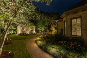 Beautiful home entrance illuminated with walkway lighting in Raleigh, NC, enhancing curb appeal and safety at night.