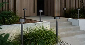 Modern home entrance with motion-sensor LED outdoor pathway bollard lights enhancing steps and landscaping safety in Raleigh, NC