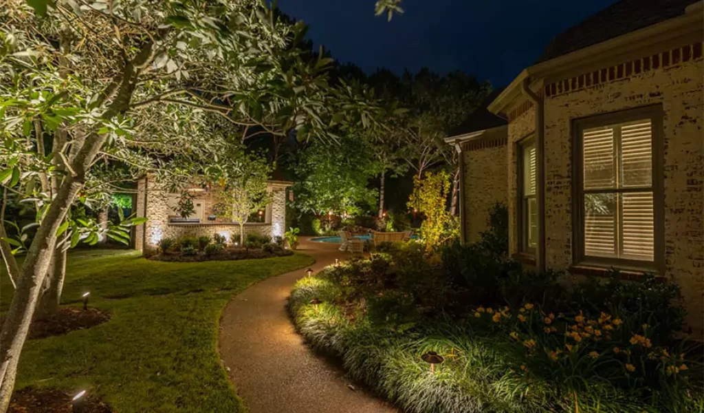 Beautiful home entrance illuminated with walkway lighting in Raleigh, NC, enhancing curb appeal and safety at night.