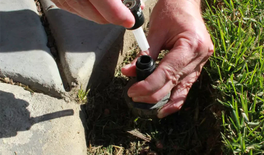 A man repairing sprinkler system in Raleigh, NC